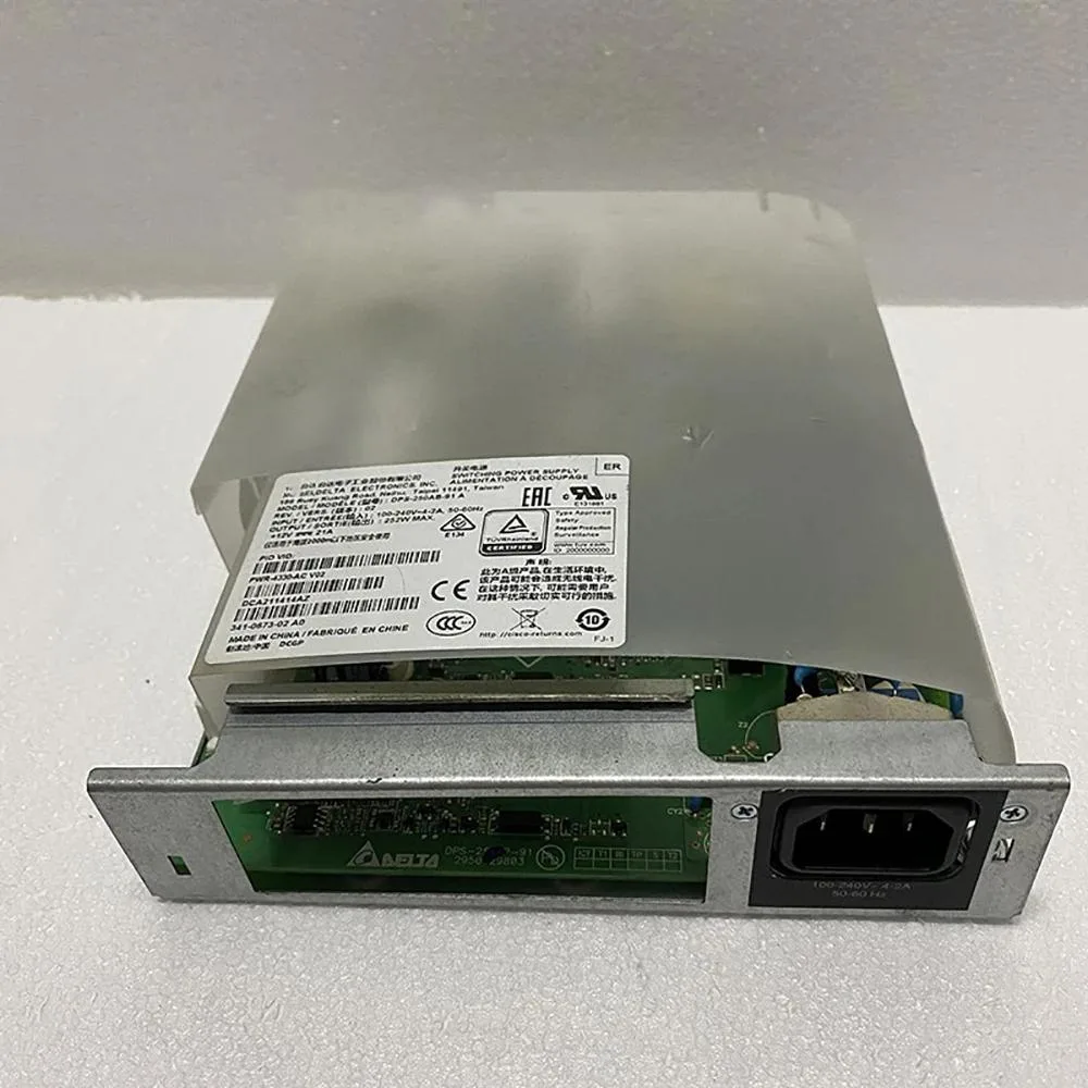 Rectangular metal PSU unit with ventilation grille and power connector visible