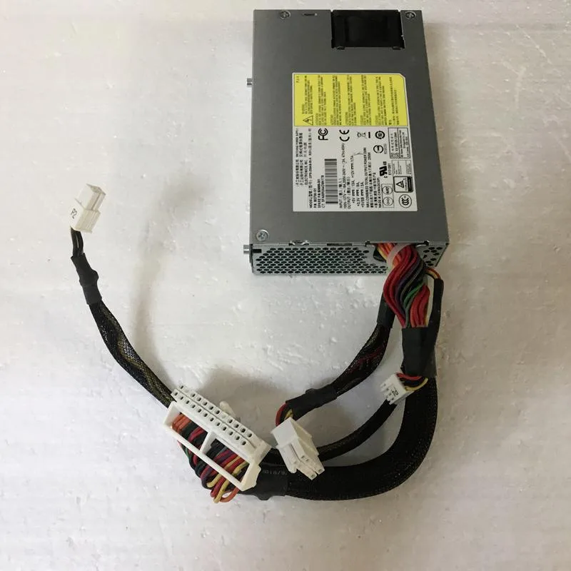 Rectangular silver metal power supply unit with ventilation grille and connector socket