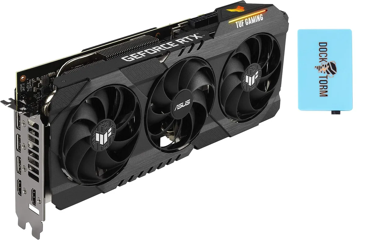 Triple-fan graphics card in dark gunmetal finish with angular shroud and visible heat pipes