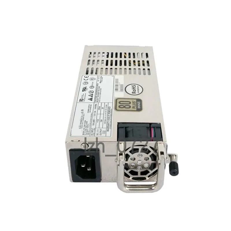 Rectangular silver metal power supply unit with ventilation grille and rear connector panel
