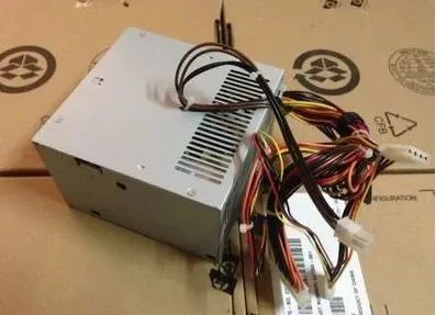 Rectangular metal ATX power supply unit with ventilation grille and connector sockets