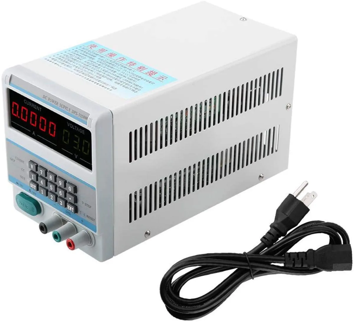 Grey metal desktop bench power supply with digital display, knobs and binding posts