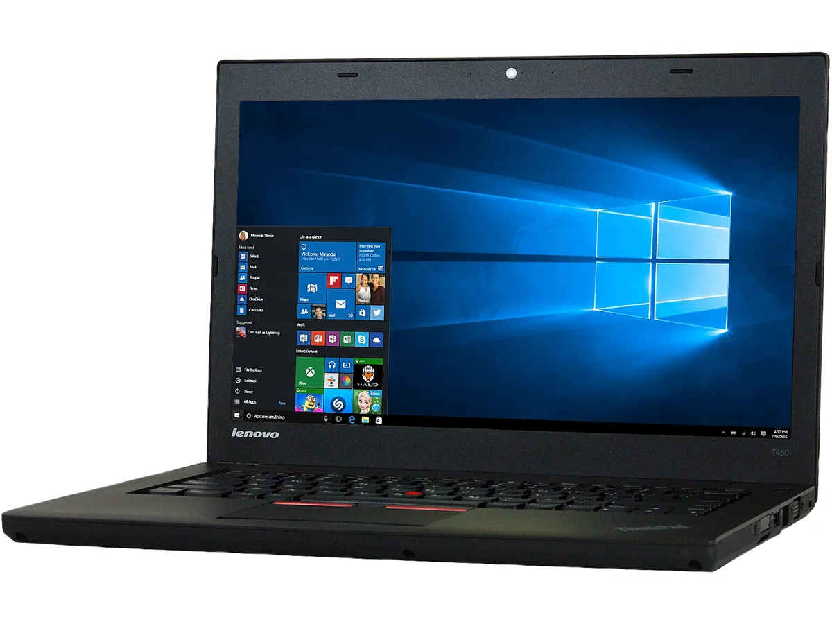 Gray Lenovo T450 laptop showing wear, dents and scuffs on chassis