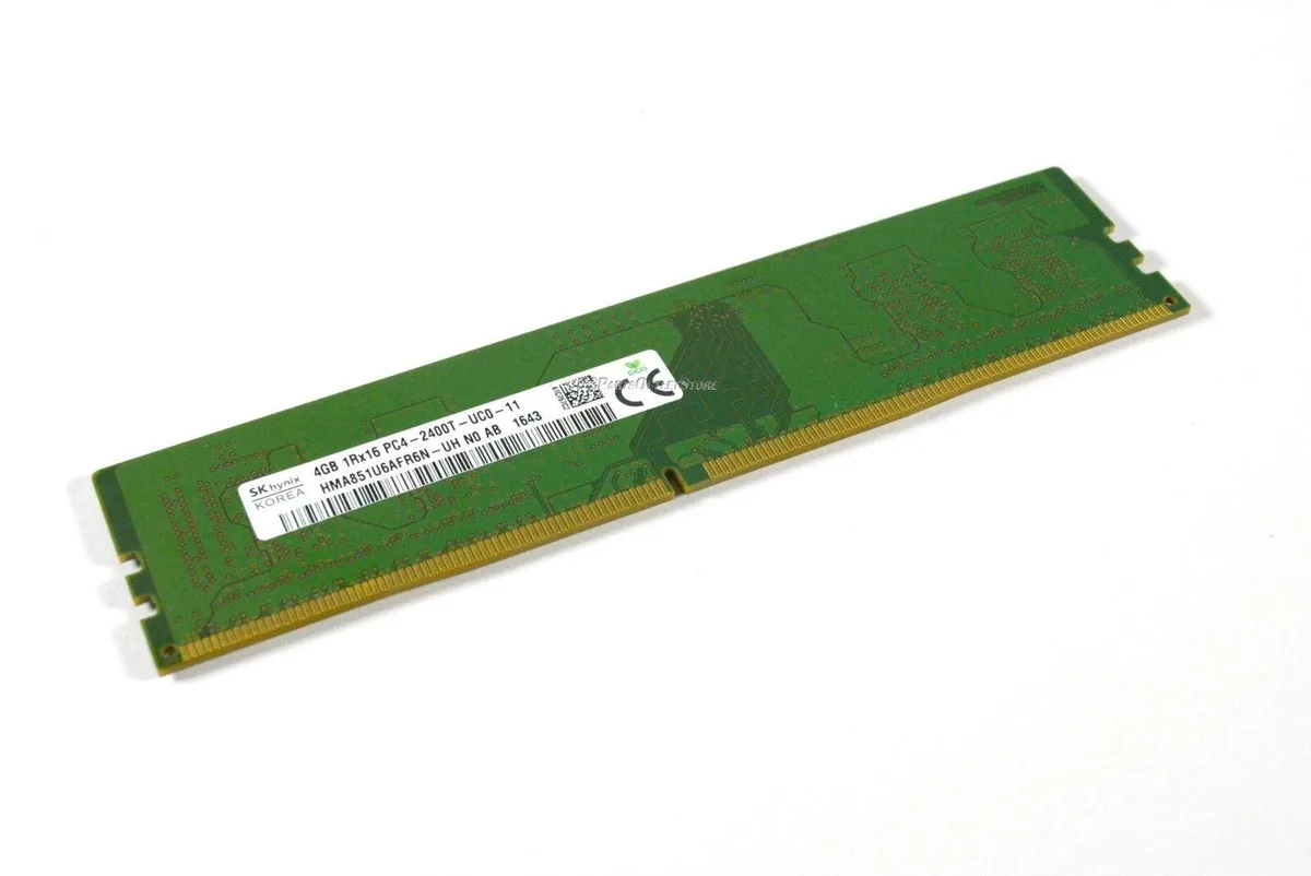 Green printed circuit board with black memory chips and gold edge contacts