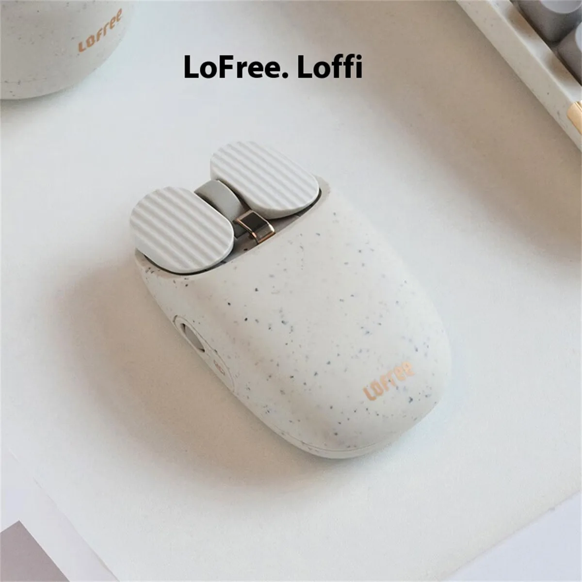 Terrazzo-patterned wireless mouse, grey ABS, 108 by 63 by 34 mm, 98 g