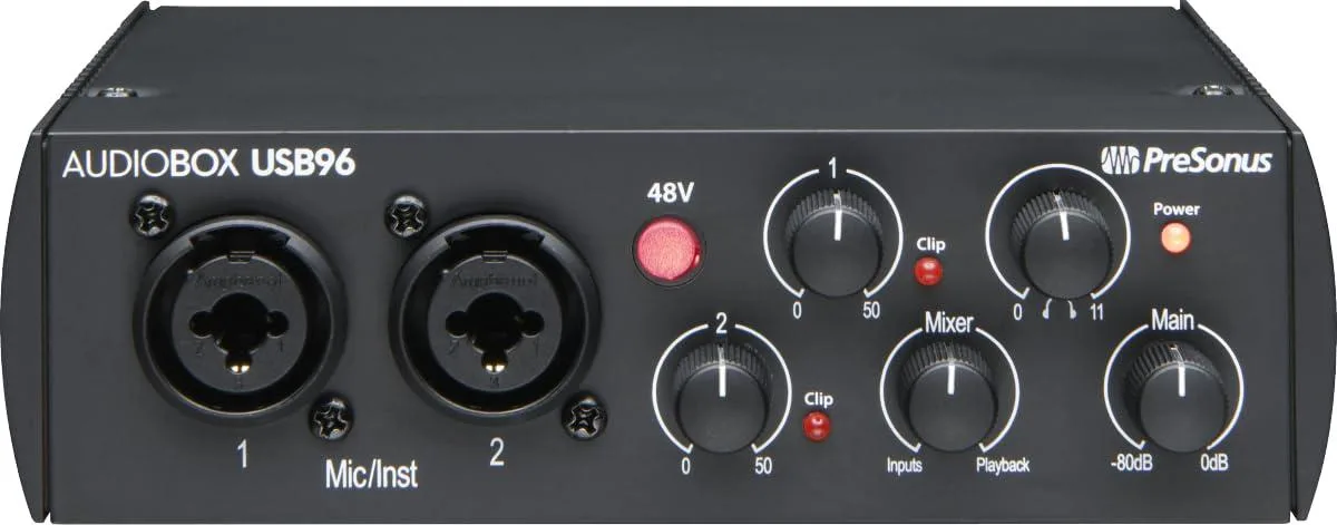Silver rectangular USB audio interface with front panel knobs and ports