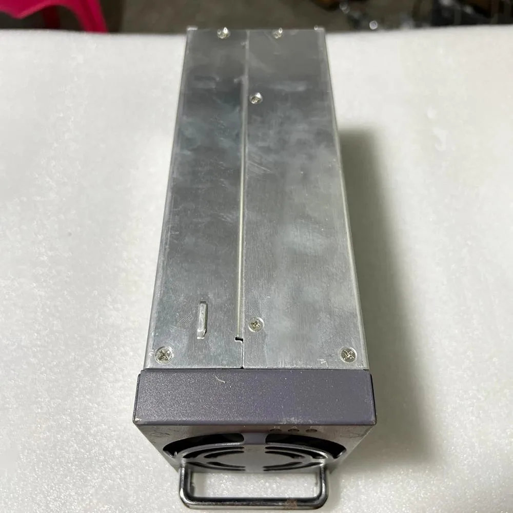 Rectangular black metal power supply module with front label and rear connector pins