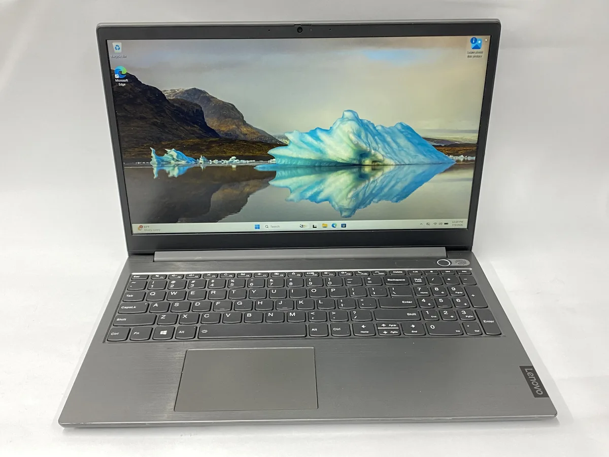 Silver Lenovo 15 inch laptop closed on a plain background