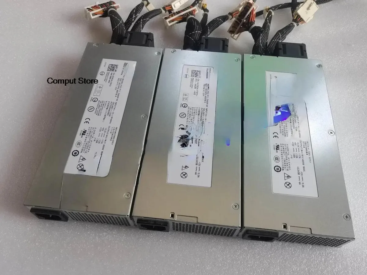 Rectangular silver server power supply unit with ventilation grille and label showing model numbers