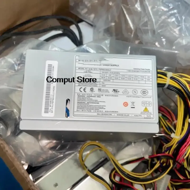 Rectangular metal ATX power supply unit with ventilation grille and label