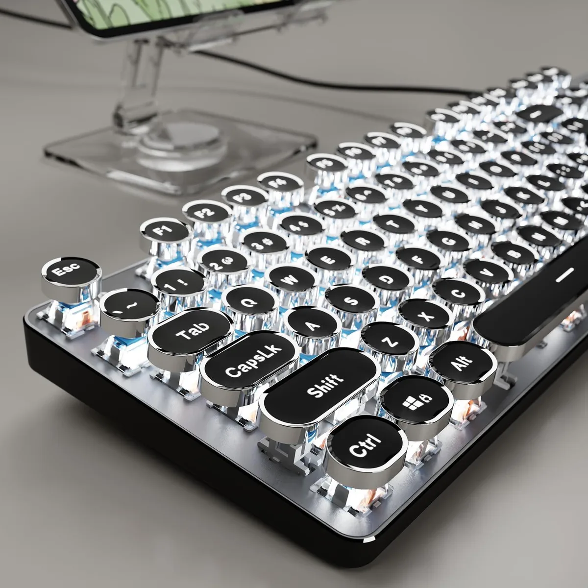 Black full-size mechanical keyboard with round silver keycaps and white backlighting on a metal panel
