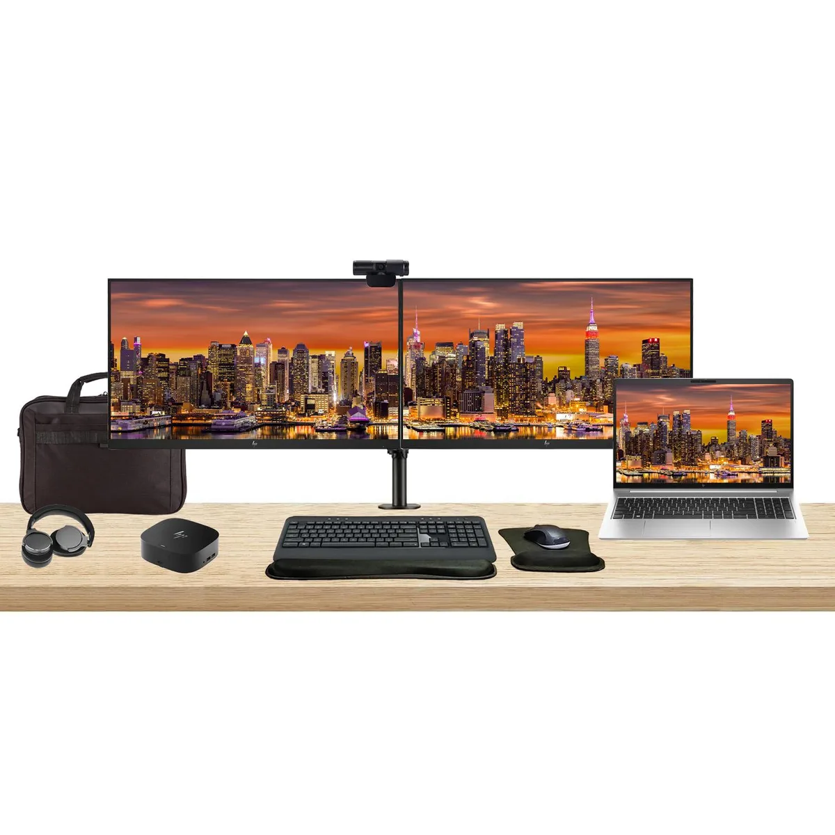 Silver laptop with two 24 inch monitors on dual stand, dock, wireless keyboard, mouse, webcam, headphones, wrist rest, briefcase