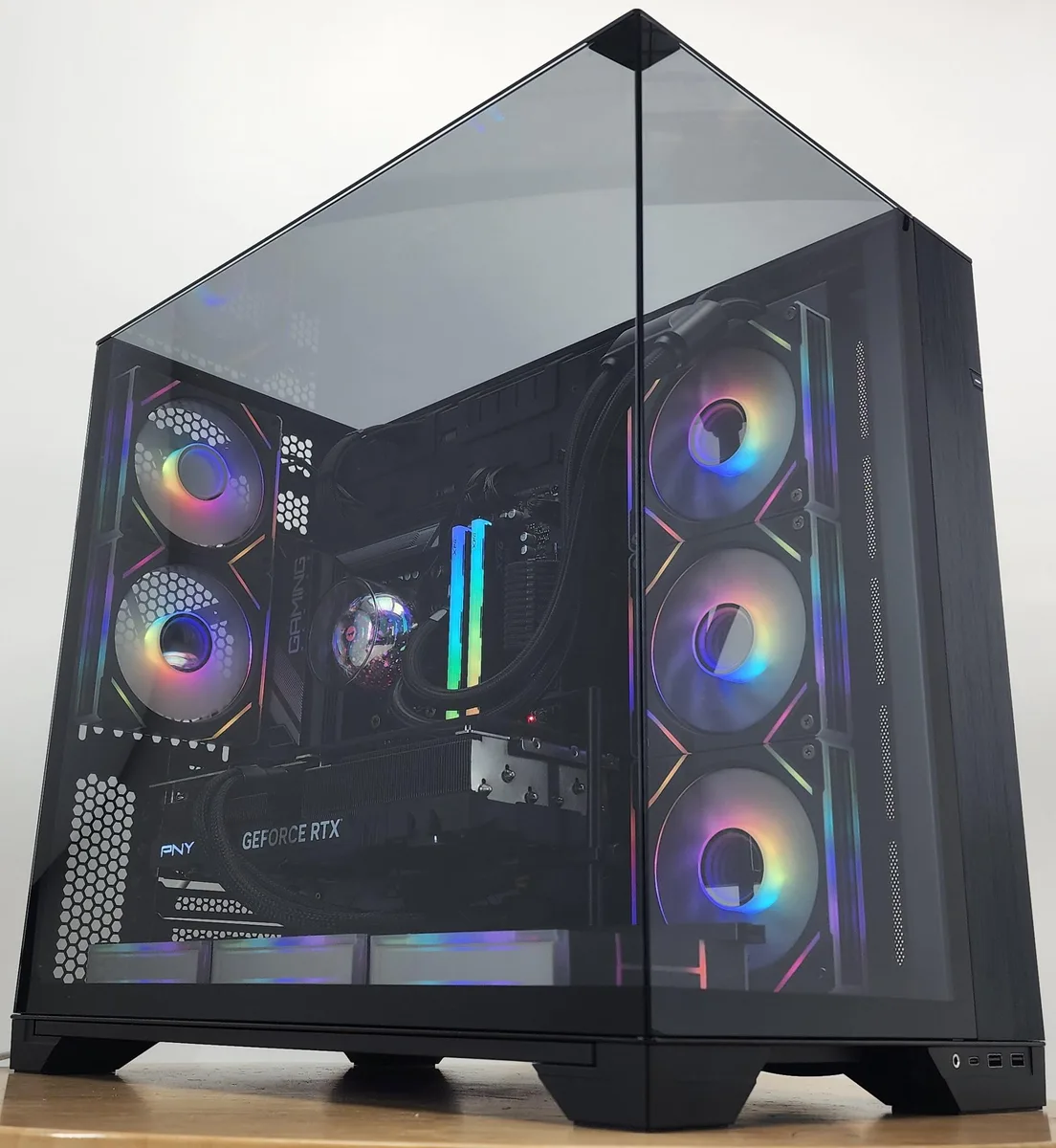 Black Lian Li O11 Vision case with 360mm AIO RGB cooler and RTX 4070 Ti SUPER graphics card visible inside
