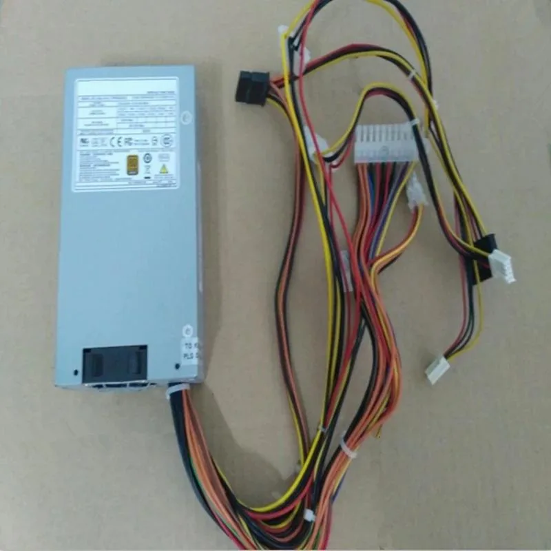 Silver 1U ATX power supply unit with rear fan grille and cable bundle