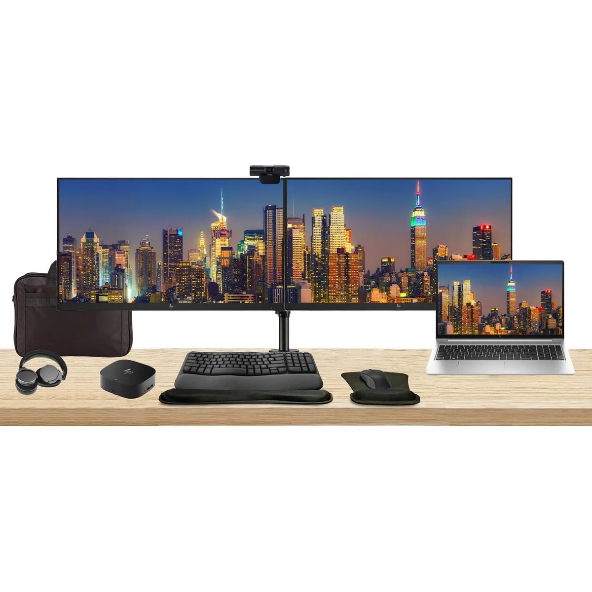 Silver laptop, two black monitors on a stand, dock, keyboard, mouse, webcam, headphones, bag