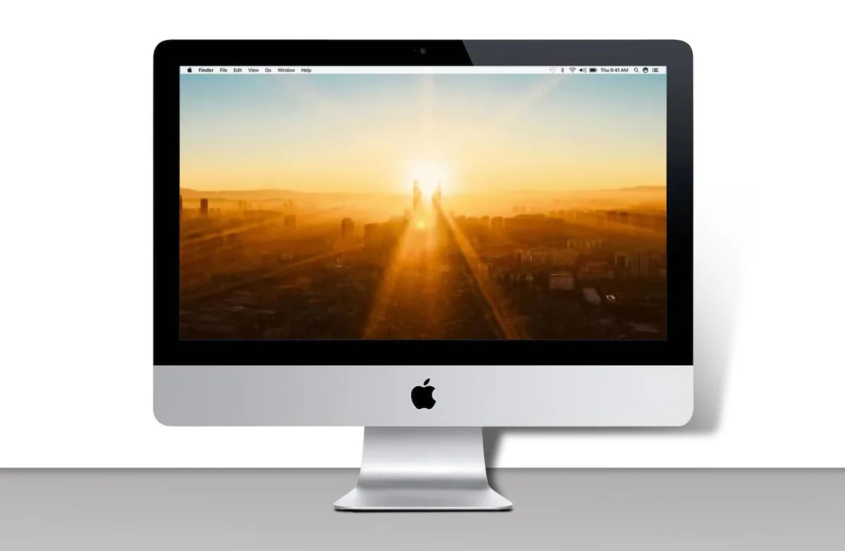 Silver all-in-one iMac with thin 21.5 inch display and included keyboard mouse