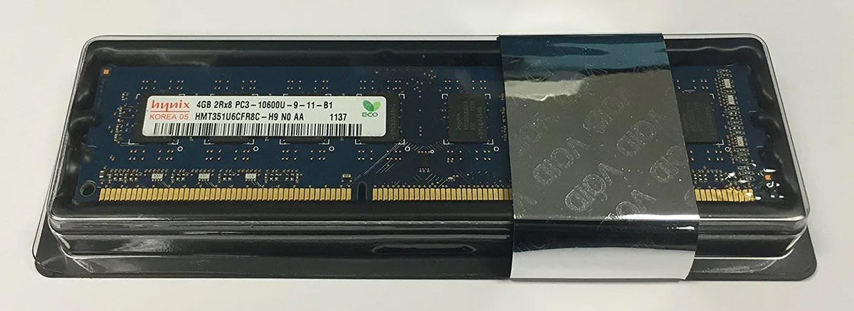 Green rectangular circuit board with black memory chips and gold edge connectors