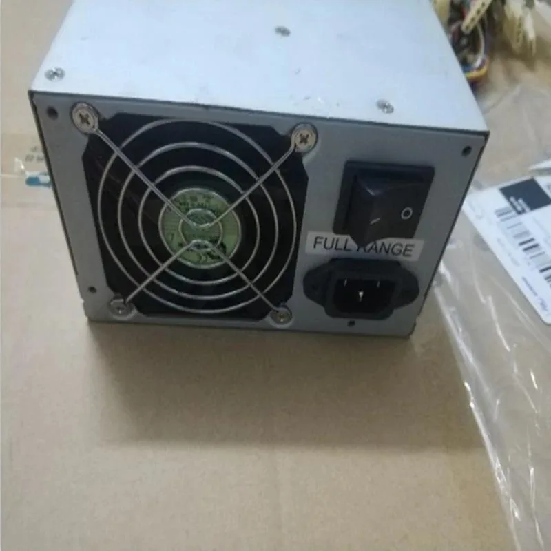 Black rectangular ATX power supply unit with fan grille and cable bundle