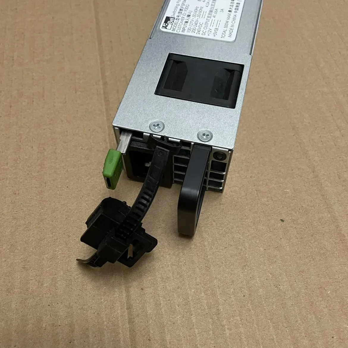 Black rectangular ATX power supply unit with cooling fan and cable bundle