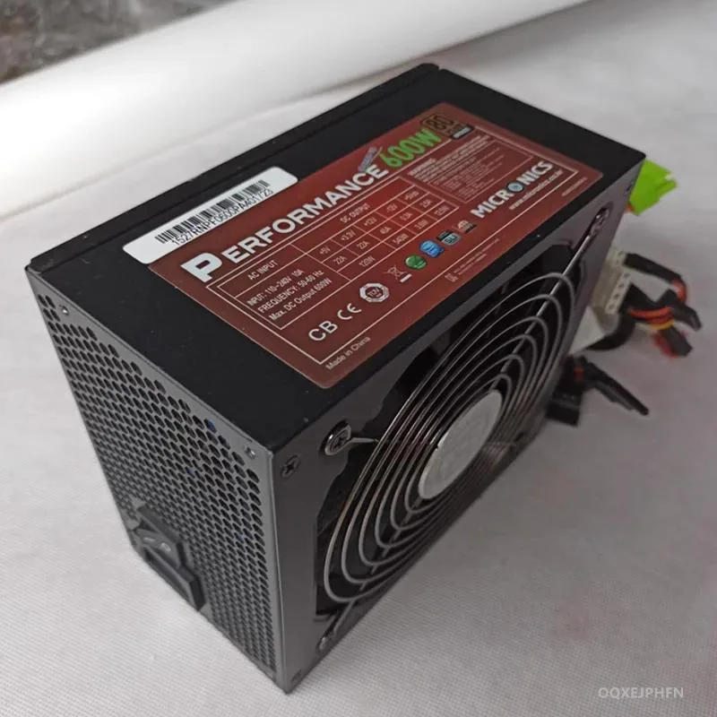 Rectangular black ATX power supply unit with fan grille and cable bundle