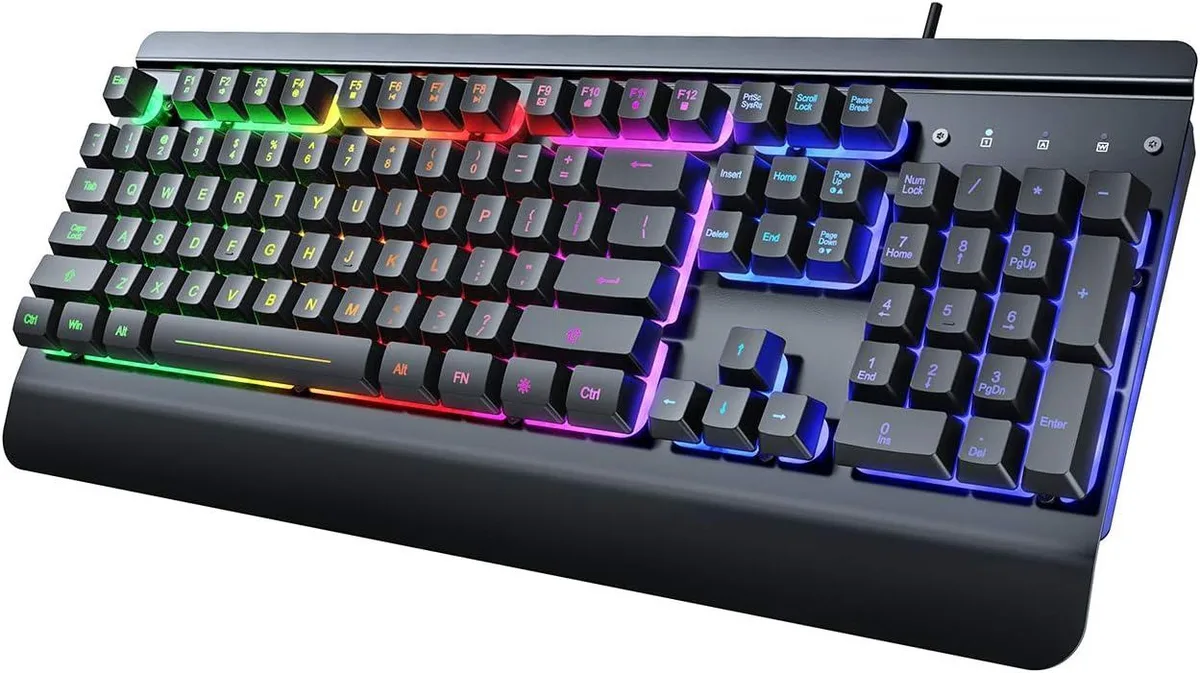 Full-size gaming keyboard with silver metal panel, rainbow backlighting and integrated wrist rest