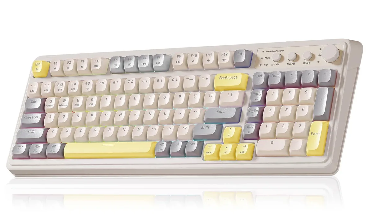 Grey and yellow full-size membrane keyboard with 99 keys, rotary knob, and RGB backlighting