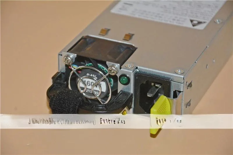 Silver rectangular server power supply unit with label showing 460W 12V 38A