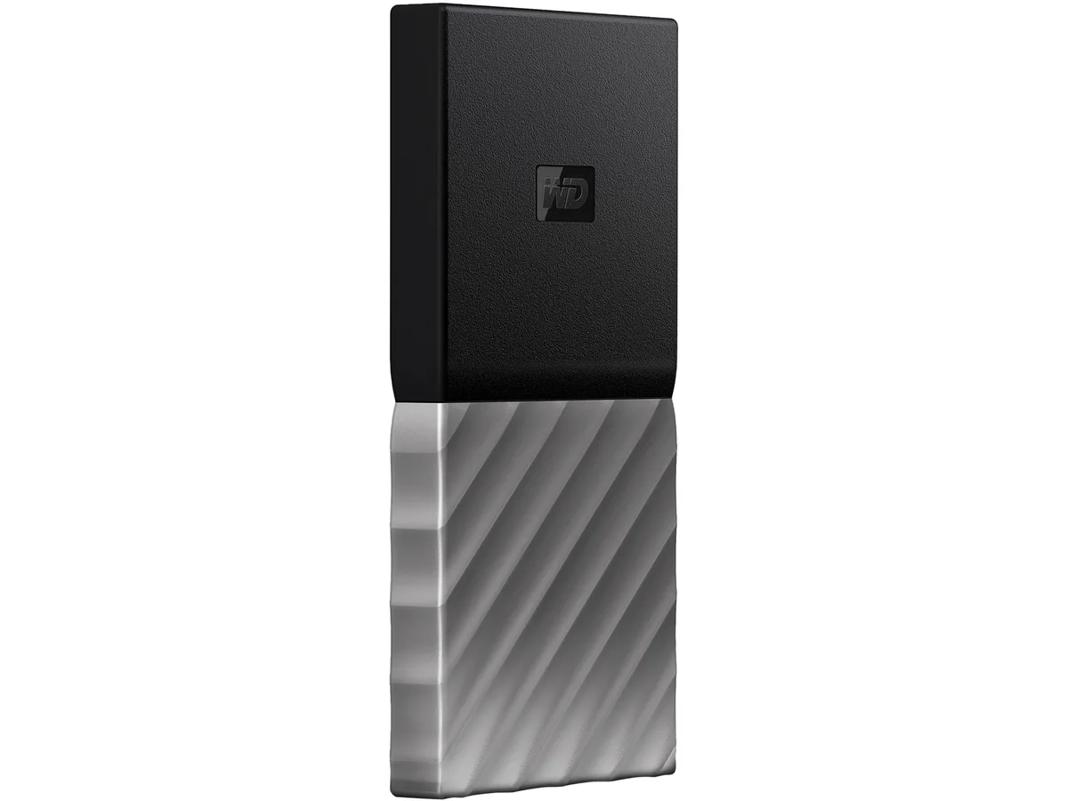 Rectangular black-top gunmetal-bottom portable SSD with USB-C cable and adapter